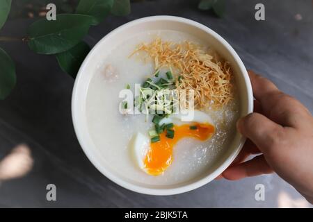 serving rice gruel, rice porridge or congee Stock Photo