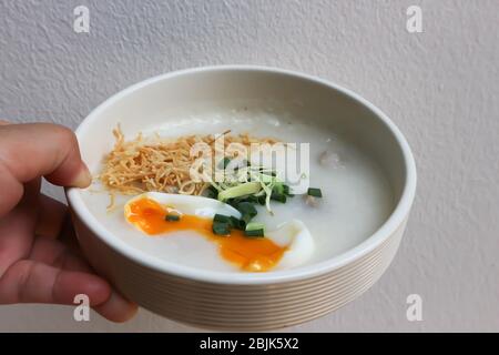 serving rice gruel, rice porridge or congee Stock Photo