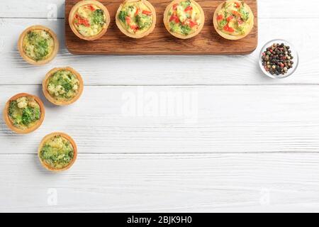 Composition with broccoli quiche tartlets on table Stock Photo