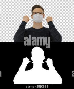 Joyful happy man taking off his protective mask The coronavirus pandemic epidemic is over, Alpha Channel Stock Photo