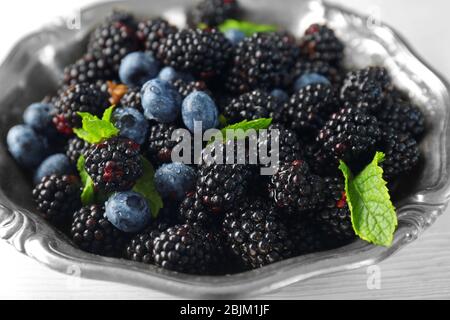 Closeup of ripe blackberries and blueberries in bowl Stock Photo