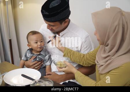 family having early breakfast before dawn. sahoor or sahur on ramadan Stock Photo