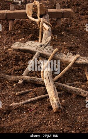 traditional wooden plough with carvings and rope Stock Photo