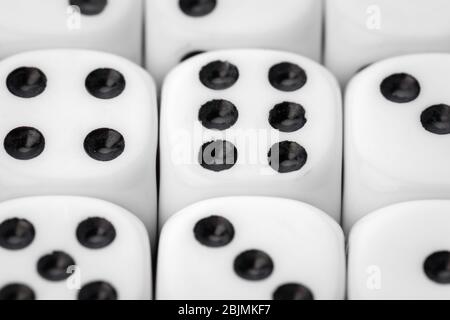 Rolling dice on a wooden desk. Close up. Stock Photo
