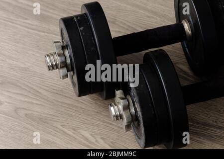 black color old rusty dumbbells on wood floor Stock Photo