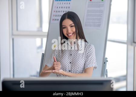 Young sign language tutor participating in online training Stock Photo