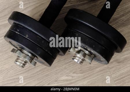black color old rusty dumbbells on wood floor Stock Photo