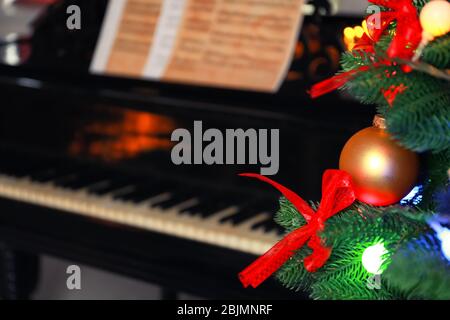 Christmas tree and piano on background Stock Photo