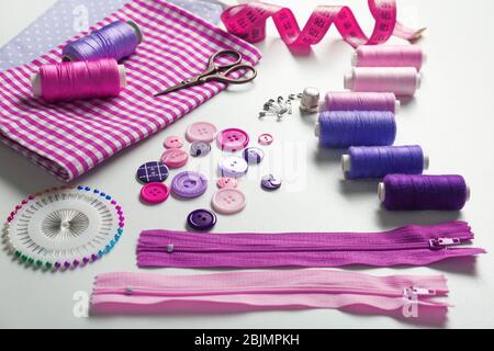 Composition with threads and sewing accessories on white background Stock Photo