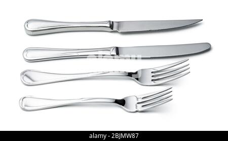 Set of silverware. Two knives and spoons isolated on white Stock Photo