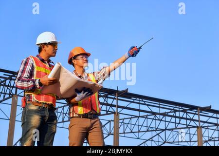Two construction engineers on a building site, Thailand Stock Photo