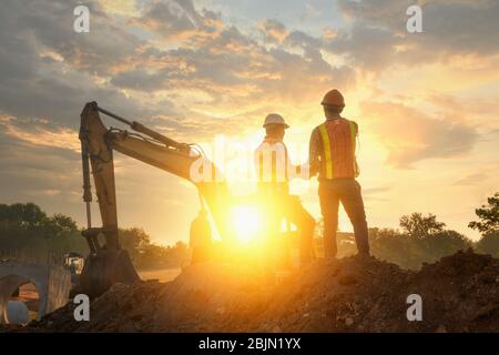 Two Engineers on a building site at sunset, Thailand Stock Photo