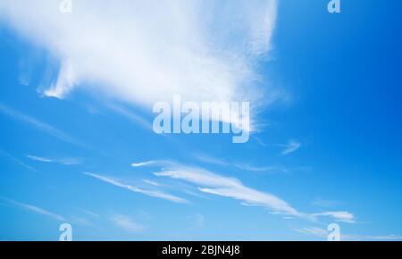Blue sky with windy cirrus clouds at daytime. Natural background photo Stock Photo