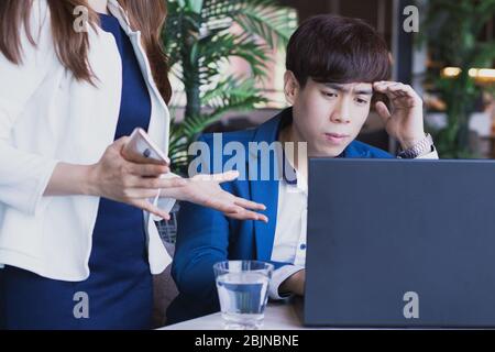 Business woman explaining about project with caucasian colleague  on common project and the business man try to understand this project in the cafe sh Stock Photo