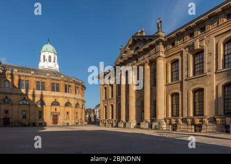 The Sheldonian Theatre on the left with the main entrance to the Bodleian Library on the right. Stock Photo