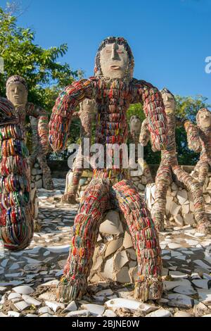 Seated figures dressed in colourful costumes Rock Garden Chandigarh Punjab India Stock Photo