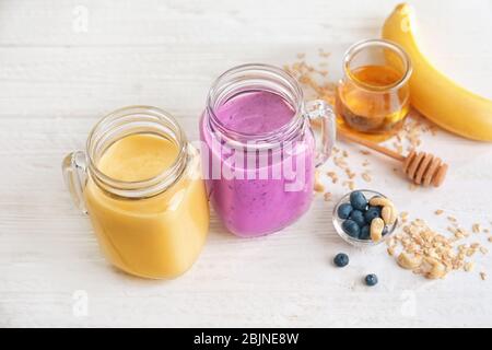 Jars with different protein shakes on table Stock Photo
