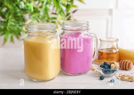 Jars with different protein shakes on table Stock Photo