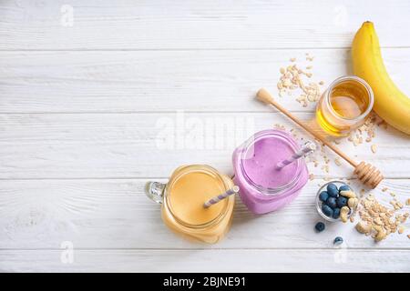 Jars with different protein shakes on table Stock Photo