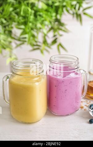Jars with different protein shakes on table Stock Photo