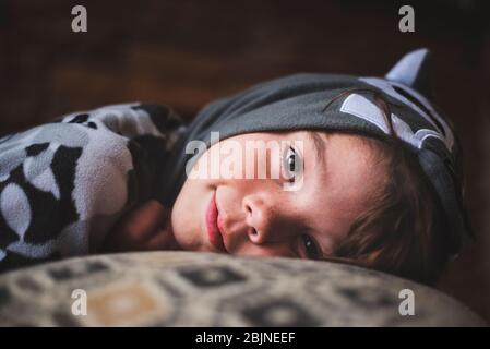 Smiling boy lying on a sofa Stock Photo