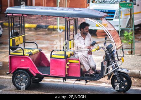 Jaipur, Rajasthan / India - September 29, 2019: Driver sitting in his Tuk Tuk, waiting for customers in Jaipur, Rajasthan, India Stock Photo