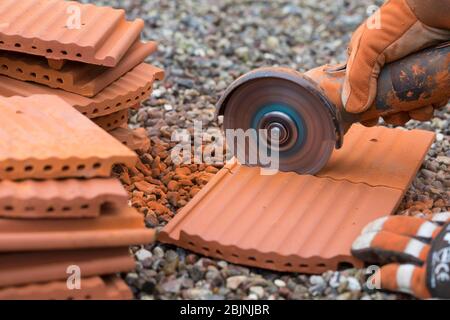 nesting aid for wild bees, interlocking pantile, step 1: cutting the pantiles in halves, Germany Stock Photo