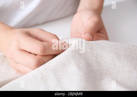 Woman sewing by hand, closeup Stock Photo