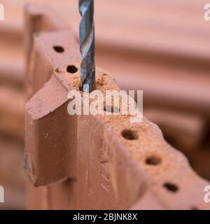 nesting aid for wild bees, interlocking pantile, step 2: edge of the holes smoothing by a drill, Germany Stock Photo