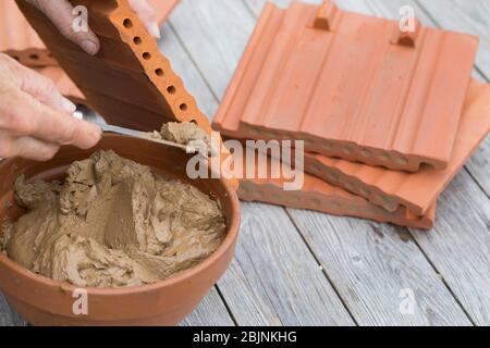 nesting aid for wild bees, interlocking pantile, step 3: on one side the holes locked with clay, Germany Stock Photo