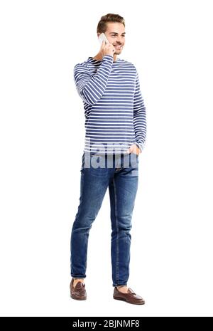 Young handsome man talking on his mobile phone against white background Stock Photo