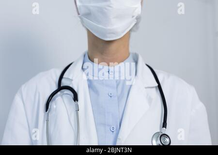 Healthcare worker wearing protective suit and face mask during coronavirus Covid19 pandemic Stock Photo