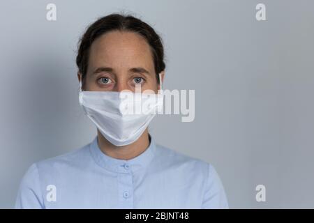 Healthcare worker wearing protective suit and face mask during coronavirus Covid19 pandemic Stock Photo