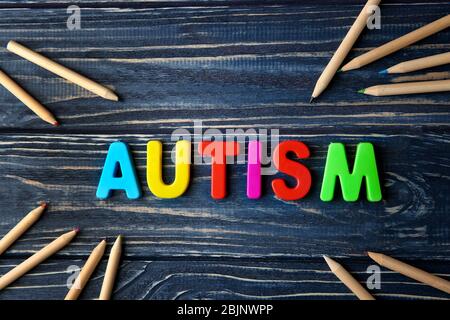 Word AUTISM made of letters on wooden background Stock Photo