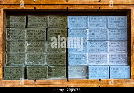 Blocks of coloured soaps stacked on shelves, Provence, France. Stock Photo