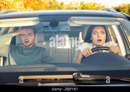 Emotional young couple in car during auto accident Stock Photo