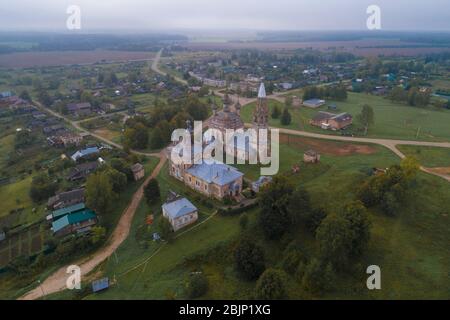 View of the old temple complex in the village of Parskoe on a foggy September morning (aerial photography). Ivanovo region, Russia Stock Photo