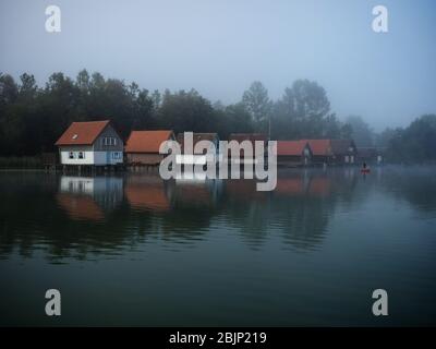 Boat houses at Grosser Alpsee in the Allgaeu in Bavaria, Germany Stock Photo