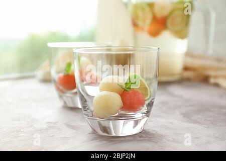 Glass with melon ball drink on table Stock Photo