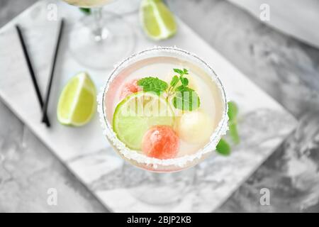 Cocktail glass with melon ball drink on table Stock Photo