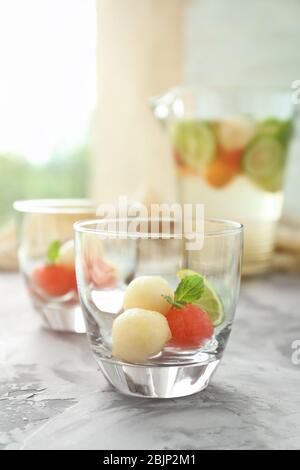 Glass with melon ball drink on table Stock Photo