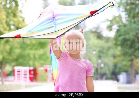 Cute little girl with colorful kite outdoors Stock Photo