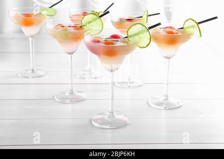 Glasses of delicious cocktails with melon balls on table Stock Photo