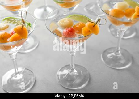 Glasses of delicious cocktails with melon balls on table Stock Photo