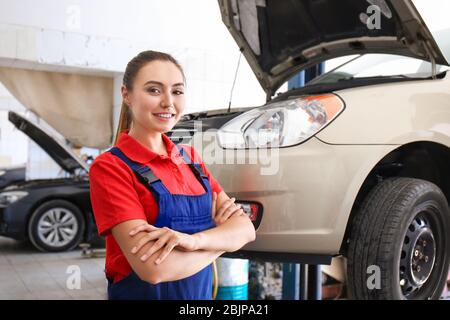 Young female mechanic in body shop Stock Photo