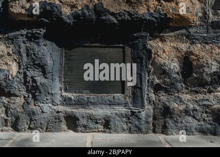 rustic air vent window on a grungy wall Stock Photo