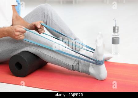 Patient doing exercise during physiotherapy session in clinic Stock Photo