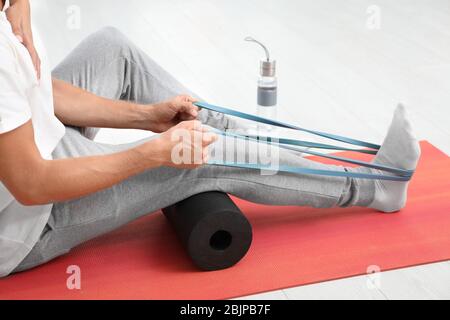 Patient doing exercise during physiotherapy session in clinic Stock Photo