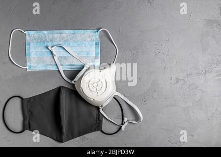 different protective masks on a gray concrete background with copy space Stock Photo