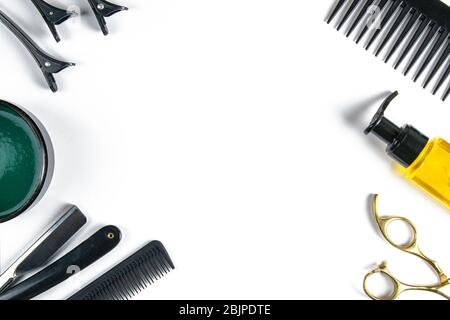 Scissors, hair clipper, combs, dangerous razor, gel for haircuts on a blue sheet on black background. Hairdressing concept Stock Photo